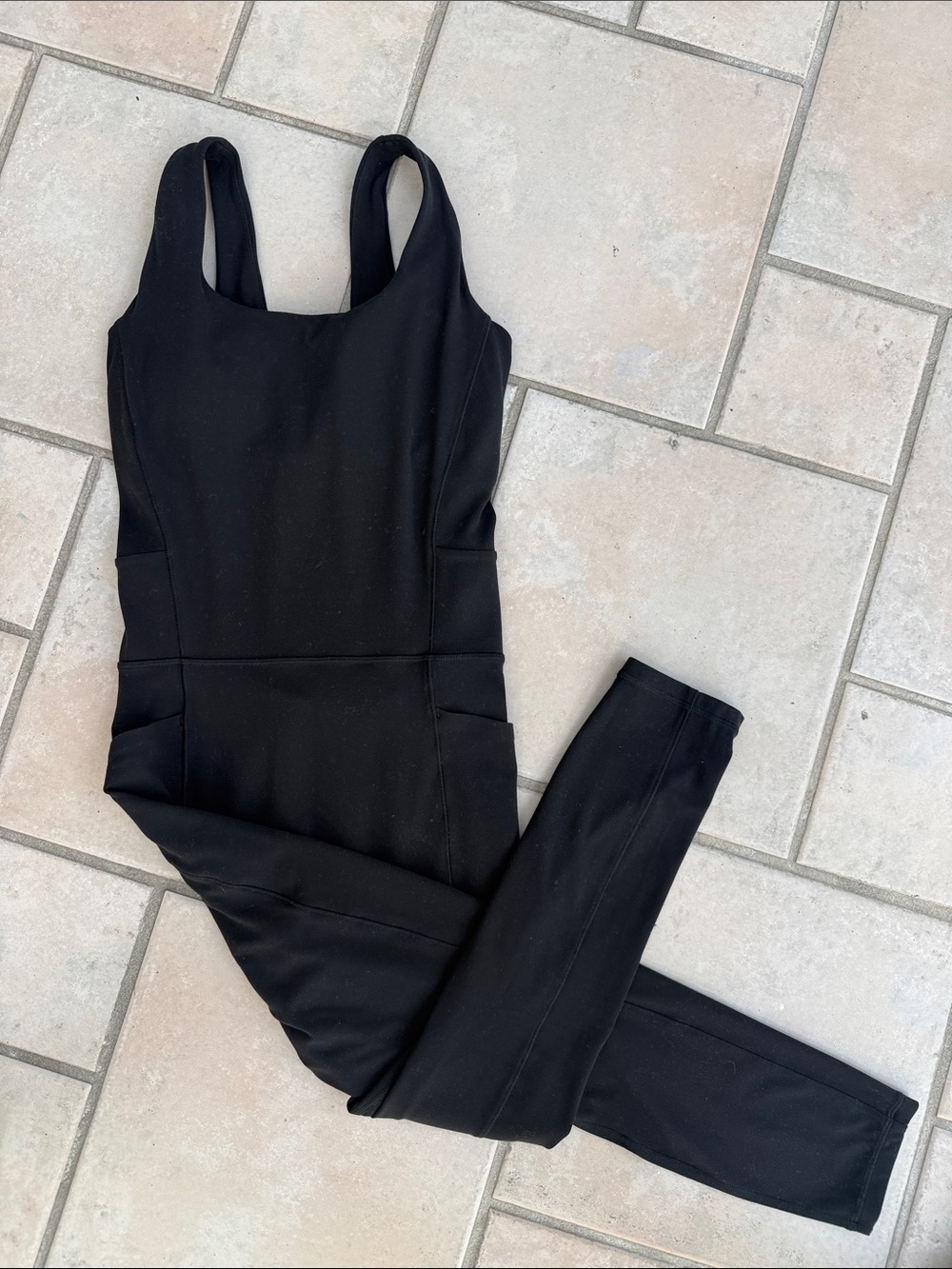 Athleta Salutation Bodysuit in Black size small with phone pockets, buttery soft